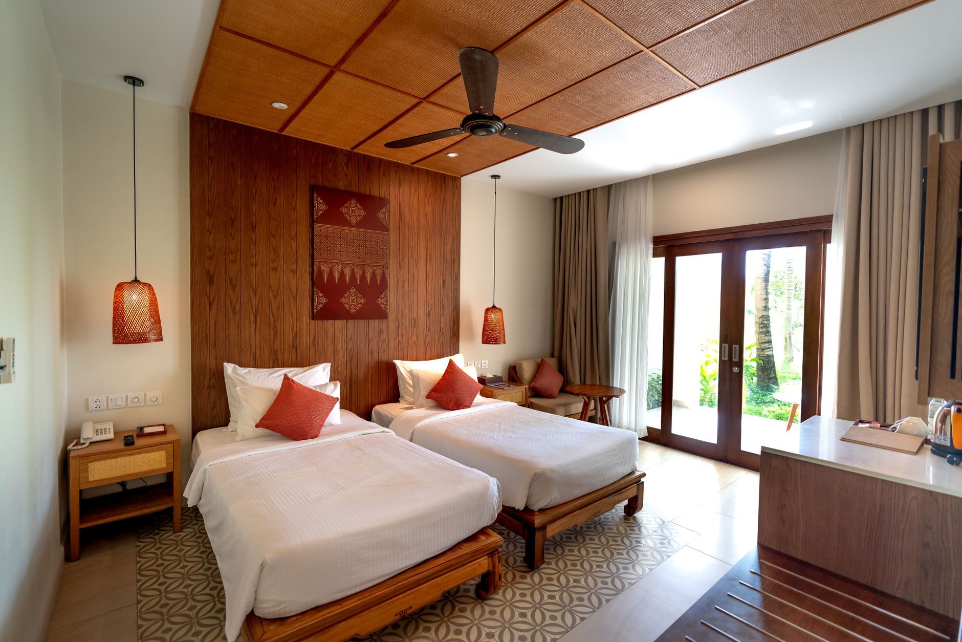 Twin timber beds in a heritage room opening to greenery